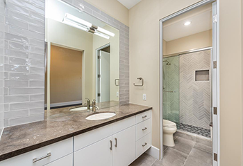 Complete bathroom remodel in Newhall showcasing contemporary tile designs and sleek glass shower.