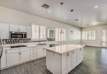 Custom kitchen design with tile backsplash and pendant lighting in Santa Clarita home.